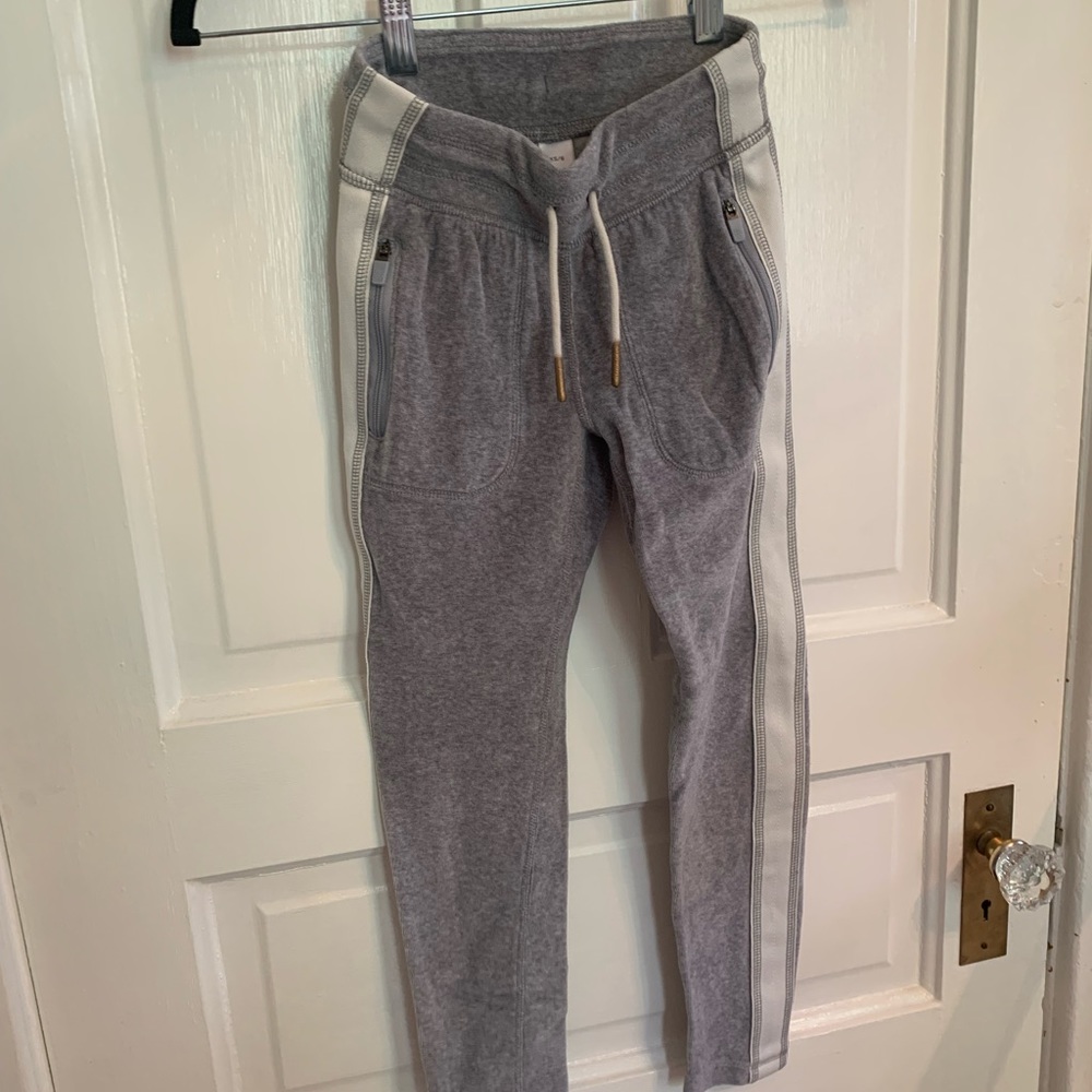 Athleta Girl gray velour track pants with white stripe down the sides.